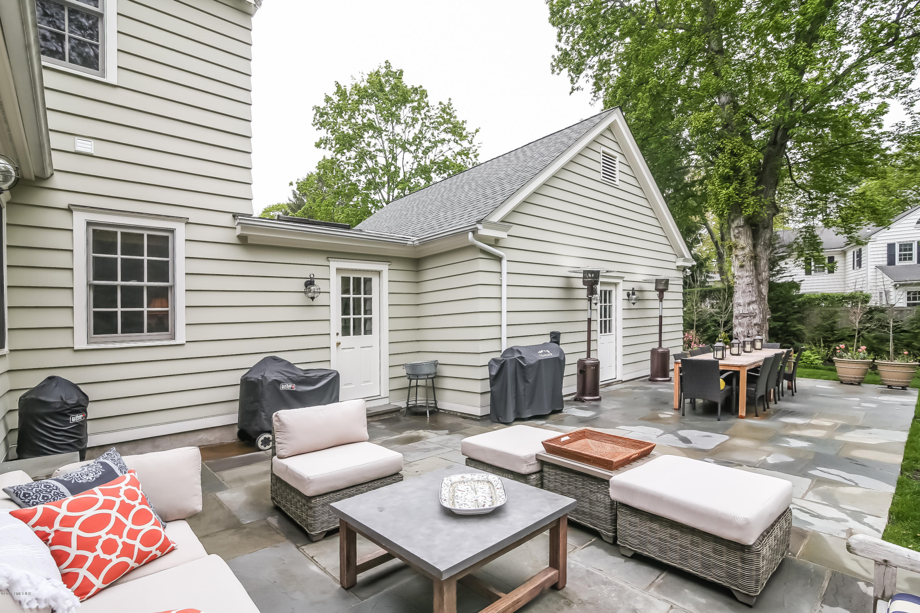 219 Riverside Avenue Riverside, CT 06878 - Photo 33 of 40 a view of a patio with couches table and chairs with wooden floor and fence