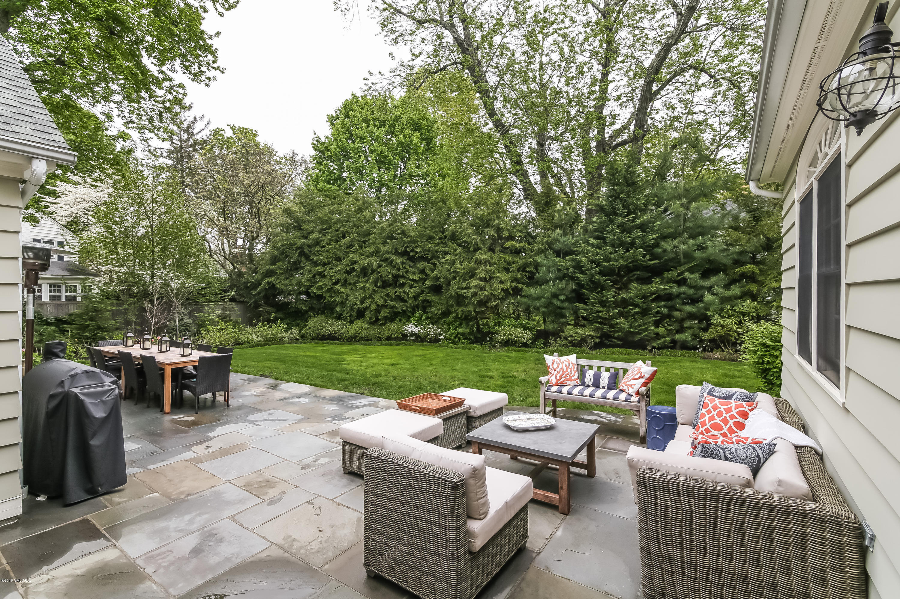 219 Riverside Avenue Riverside, CT 06878 - Photo 35 of 40 a view of a patio with couches and a table and chairs with wooden fence