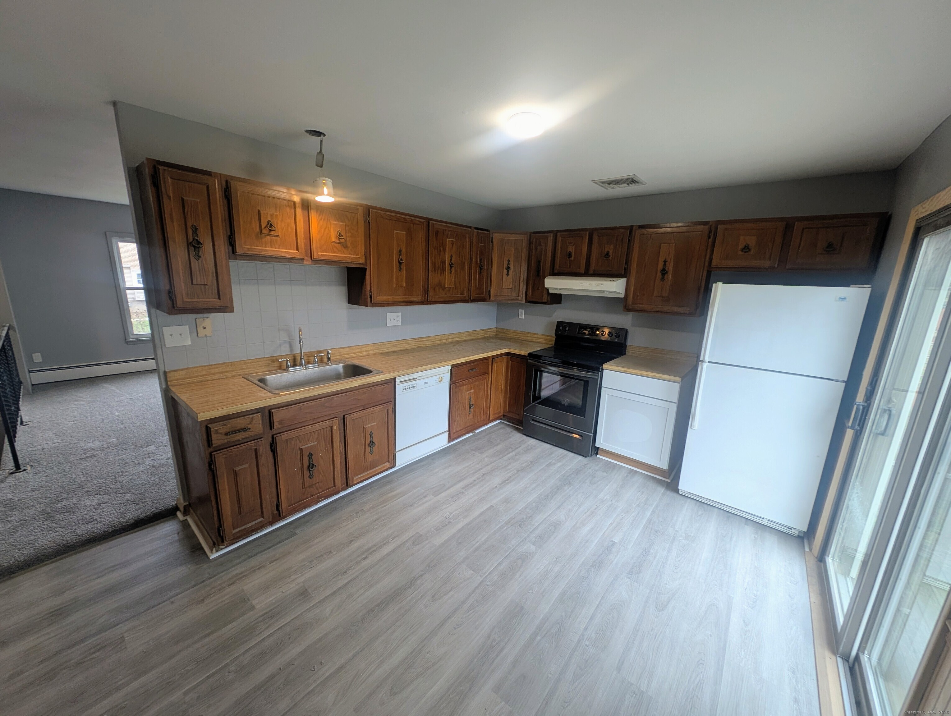 30 Cardinal Lane Naugatuck, CT 06770 - Photo 3 of 9 a kitchen with wooden floors and white stainless steel appliances