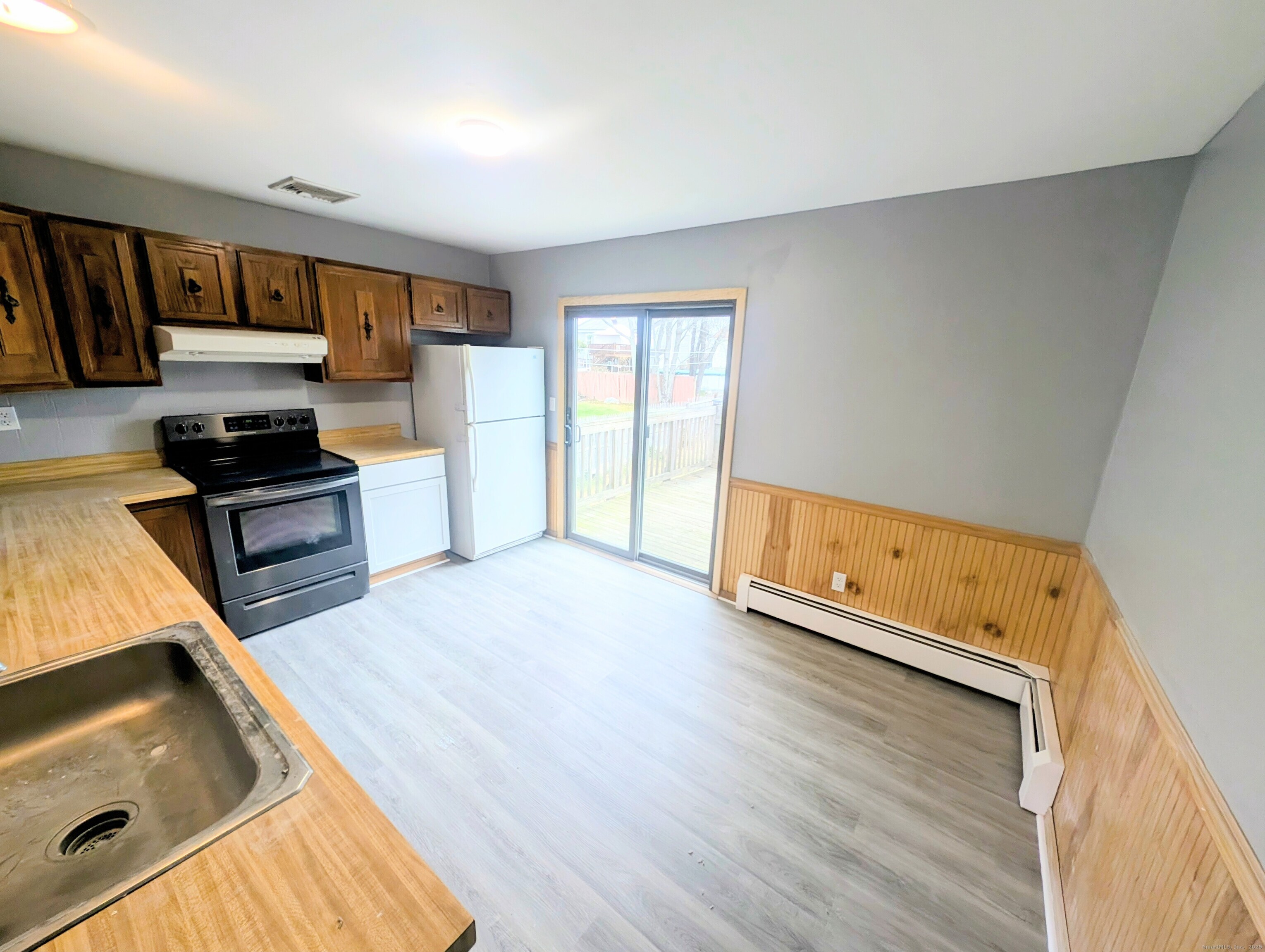 30 Cardinal Lane Naugatuck, CT 06770 - Photo 4 of 9 a kitchen with stainless steel appliances granite countertop a sink dishwasher stove and wooden floor