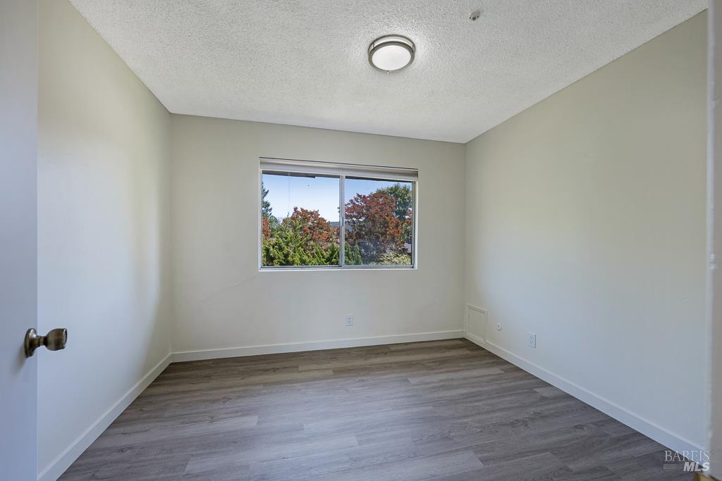 1155-1175 Evans Drive Santa Rosa, CA 95405 - Photo 29 of 31 an empty room with wooden floor and windows