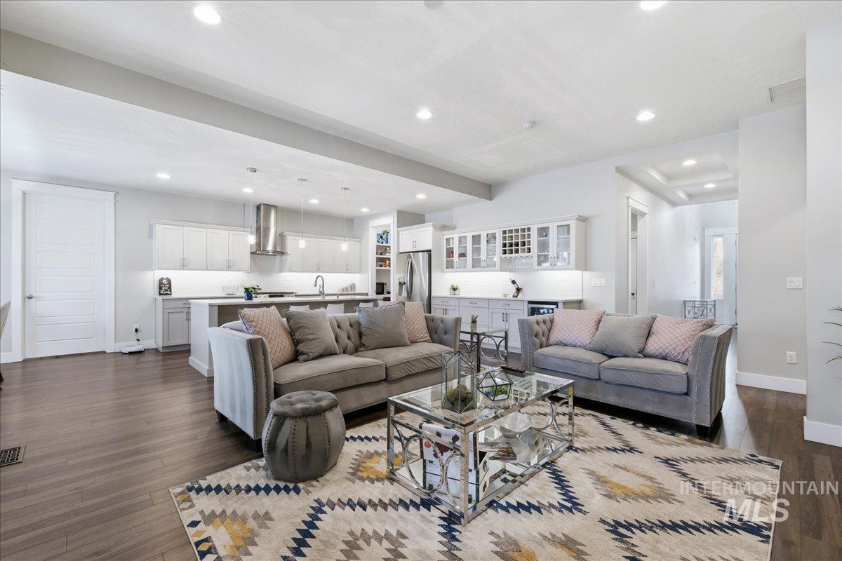 5154 South Twilight Mist Way Meridian, ID 83642 - Photo 11 of 47 Living area featuring dark wood-style flooring, recessed lighting, and beverage cooler