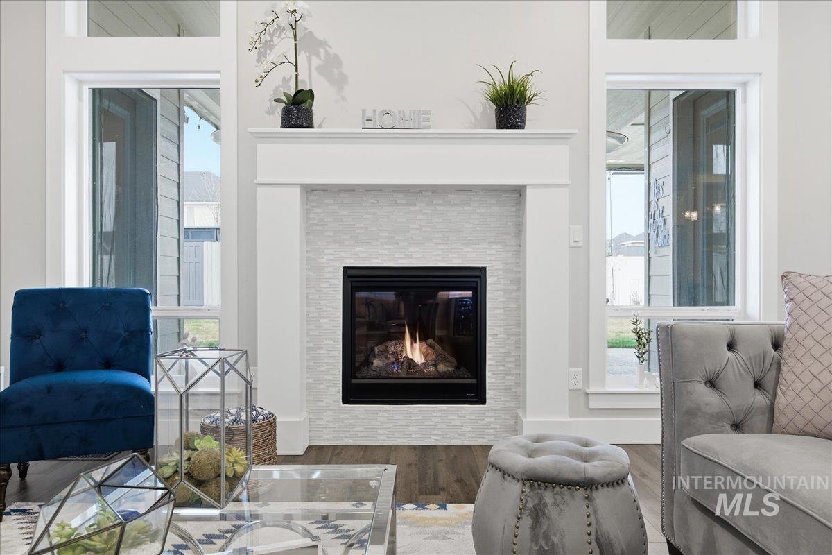 5154 South Twilight Mist Way Meridian, ID 83642 - Photo 12 of 47 Living area with a fireplace and wood finished floors