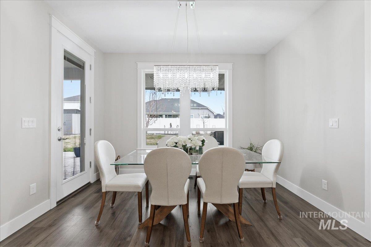 5154 South Twilight Mist Way Meridian, ID 83642 - Photo 19 of 47 Dining area featuring dark wood-style floors and a chandelier