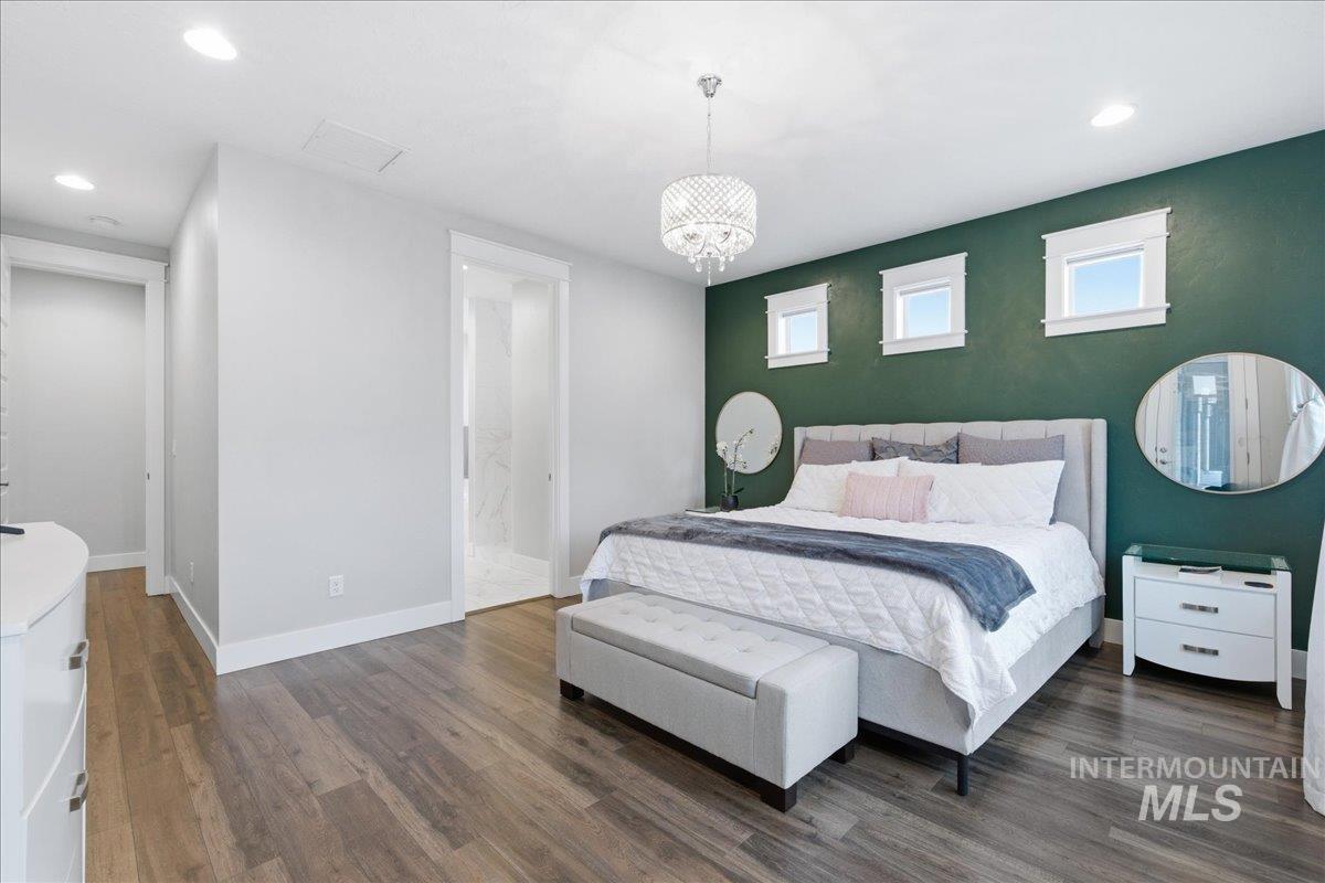 5154 South Twilight Mist Way Meridian, ID 83642 - Photo 21 of 47 Bedroom featuring dark wood-style flooring and a chandelier