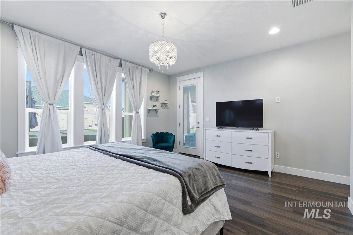 5154 South Twilight Mist Way Meridian, ID 83642 - Photo 22 of 47 Bedroom with hanging lights, dark wood finished floors, and access to outside