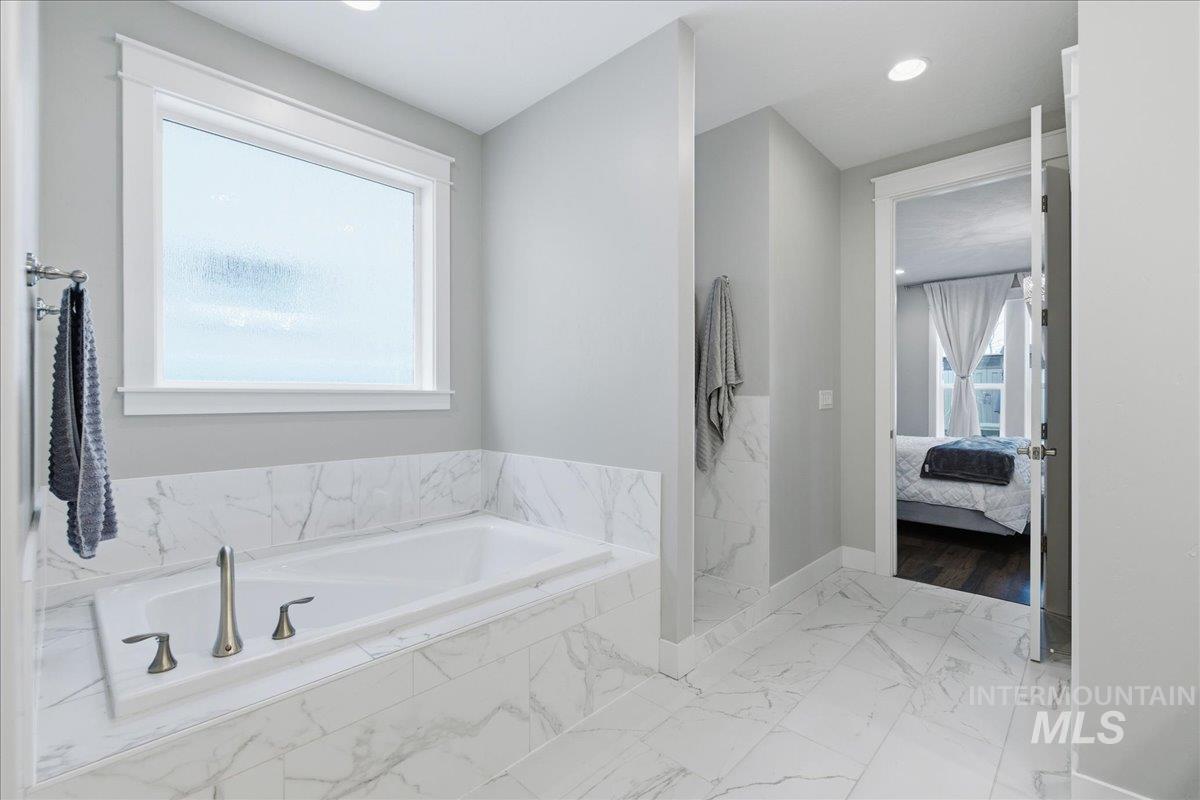5154 South Twilight Mist Way Meridian, ID 83642 - Photo 27 of 47 Ensuite bathroom with light marble finish floors, a garden tub, a marble finish shower, and recessed lighting