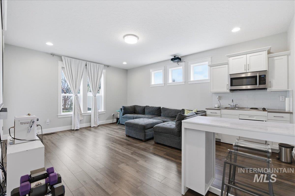 5154 South Twilight Mist Way Meridian, ID 83642 - Photo 29 of 47 Living room with dark wood-type flooring and recessed lighting