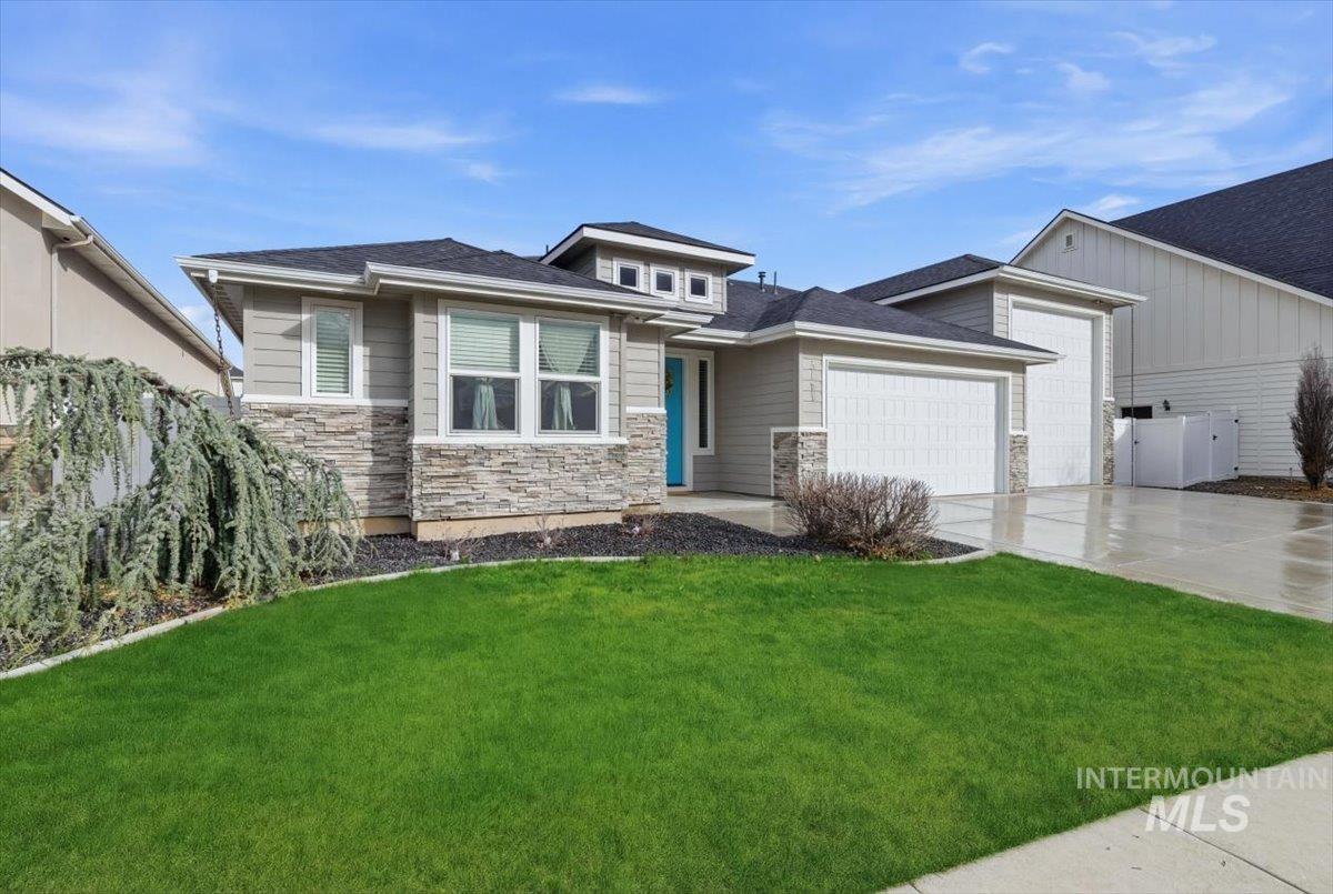 5154 South Twilight Mist Way Meridian, ID 83642 - Photo 3 of 47 View of front of home with stone siding, a front lawn, an attached garage, and driveway