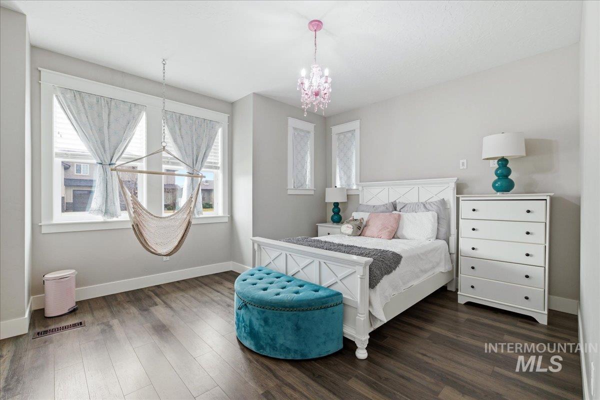 5154 South Twilight Mist Way Meridian, ID 83642 - Photo 36 of 47 Bedroom featuring suspended lighting and wood finished floors