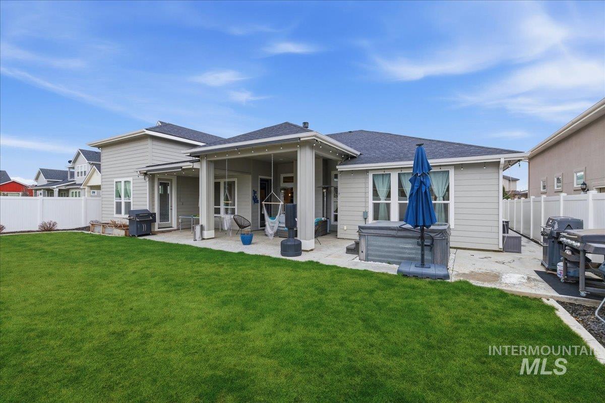 5154 South Twilight Mist Way Meridian, ID 83642 - Photo 37 of 47 Rear view of property with a fenced backyard, a hot tub, a patio, and roof with shingles