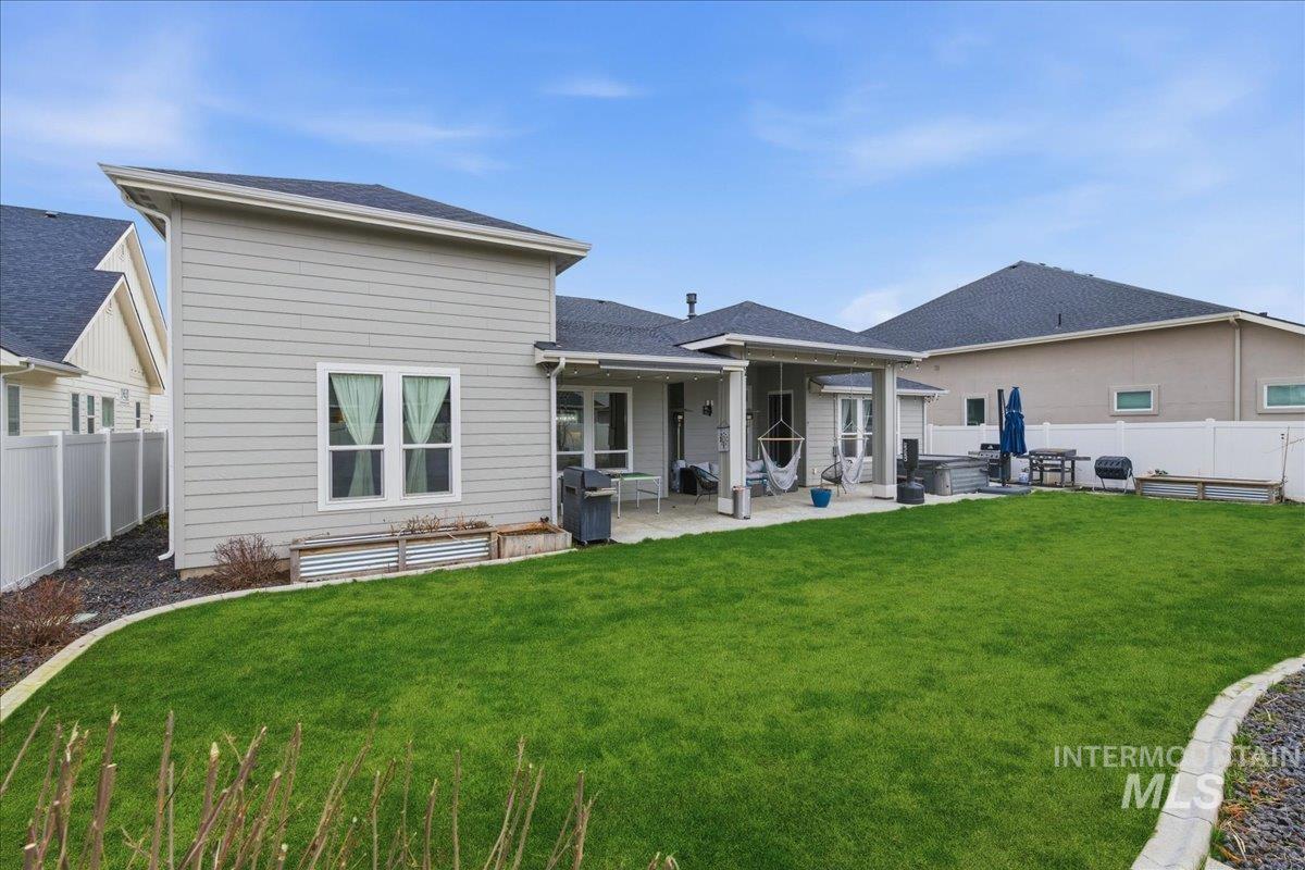 5154 South Twilight Mist Way Meridian, ID 83642 - Photo 39 of 47 Back of house with a fenced backyard, a patio area, and a shingled roof