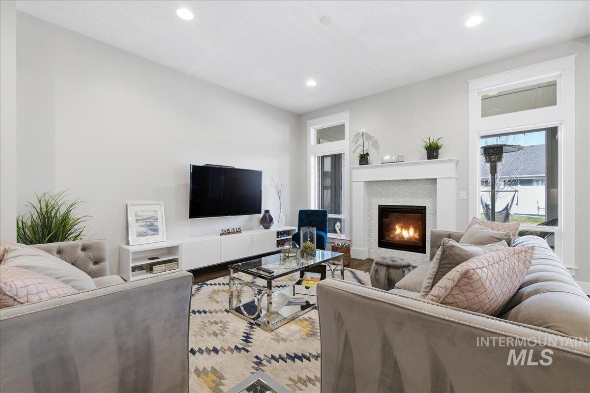 5154 South Twilight Mist Way Meridian, ID 83642 - Photo 9 of 47 Living area with wood finished floors, recessed lighting, and a glass covered fireplace