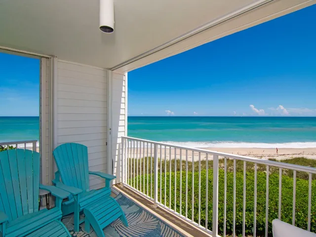 a balcony with table and chairs