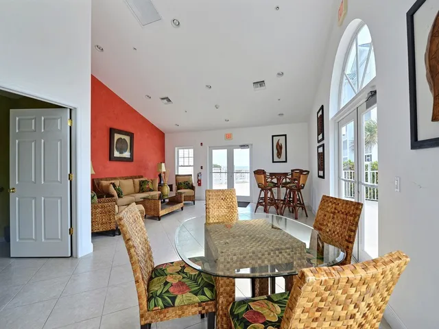 a dining room with furniture a rug and a painting
