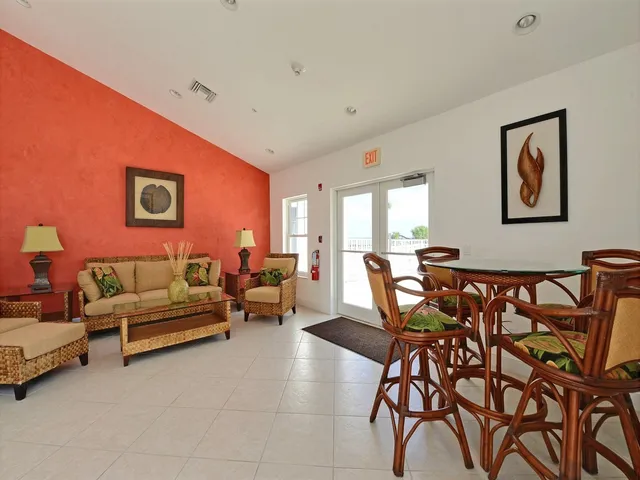 a living room with furniture and a black wall painting