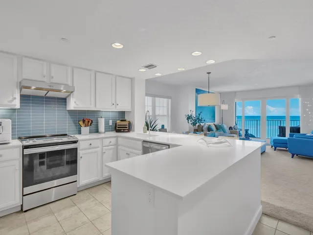 a kitchen with sink cabinets and stove top oven