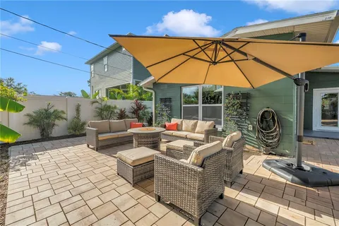 a view of a house with backyard and sitting area