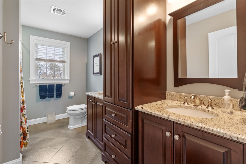 17 Applegate Road Medway, MA 02053 - Photo 32 of 42 a bathroom with a granite countertop sink toilet and shower