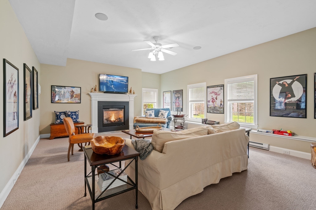 17 Applegate Road Medway, MA 02053 - Photo 36 of 42 a living room with furniture a fireplace and a flat screen tv