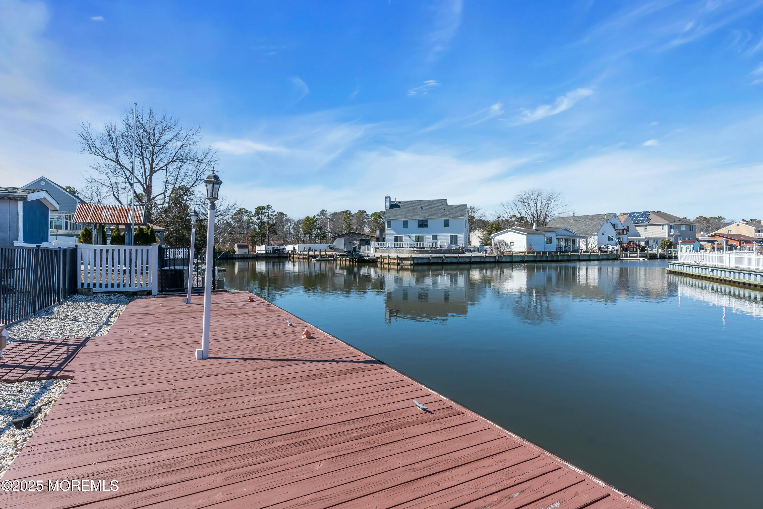 10 Commodore Drive Brick, NJ 08723 - Photo 2 of 27 a wooden pier with boats and lake view