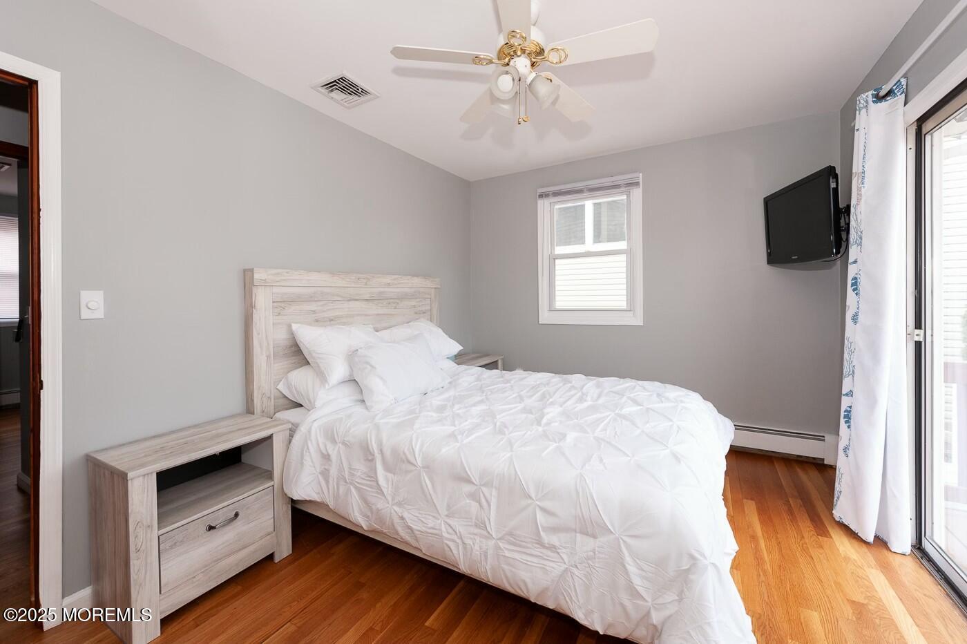 10 Commodore Drive Brick, NJ 08723 - Photo 27 of 27 a bedroom with a bed and wooden floor