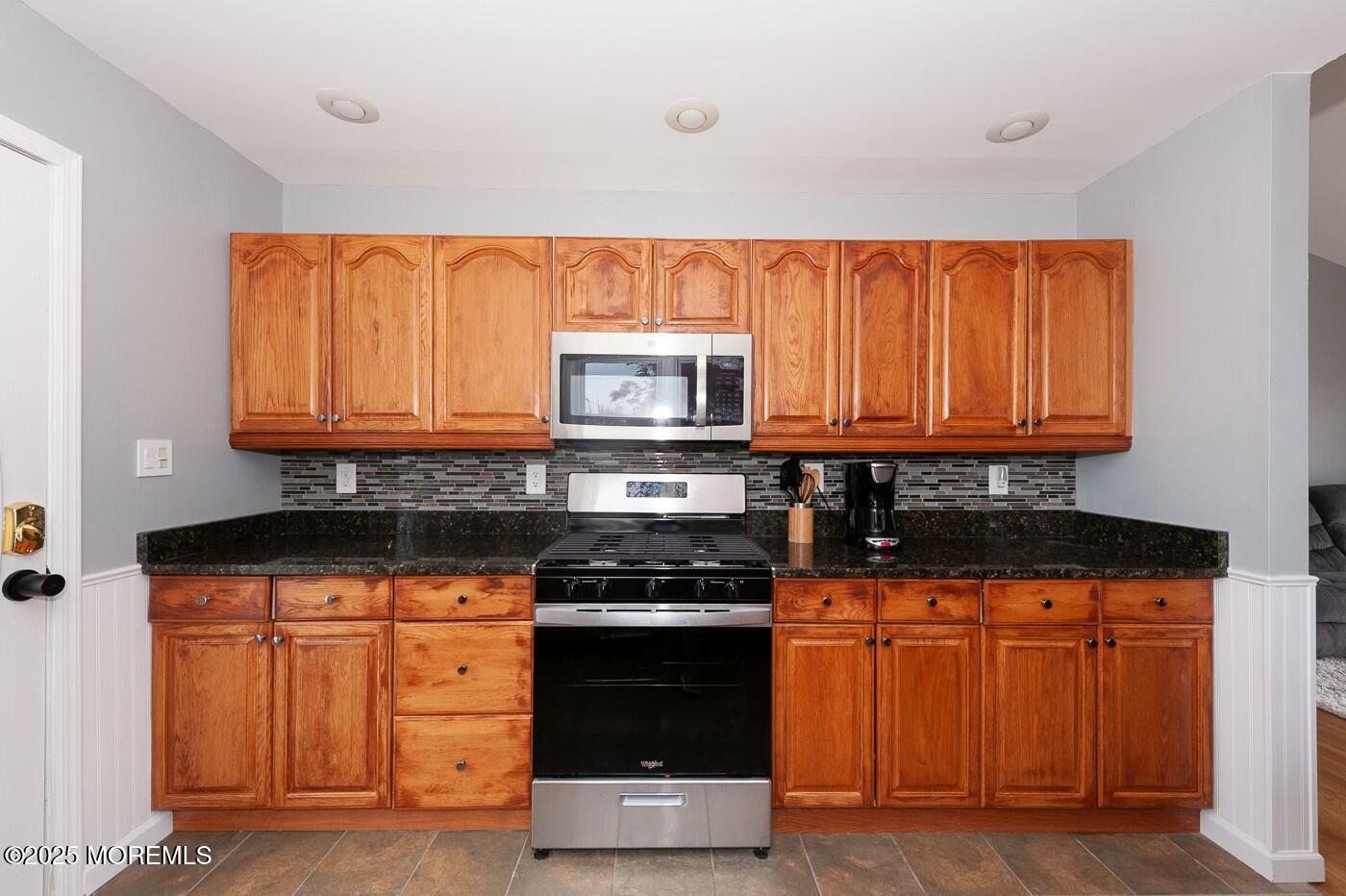 10 Commodore Drive Brick, NJ 08723 - Photo 7 of 27 a kitchen with wooden cabinets and a stove top oven