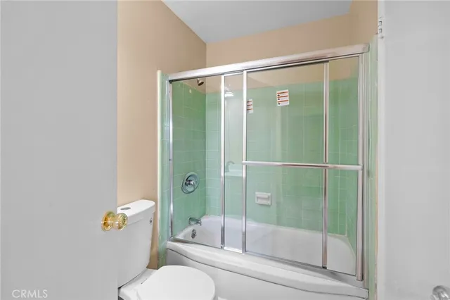 a bathroom with a shower and toilet