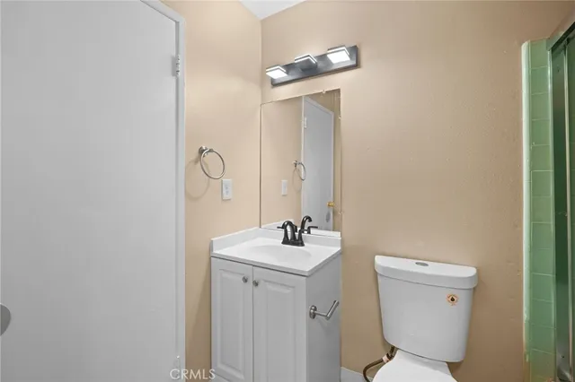 a bathroom with a sink mirror and toilet