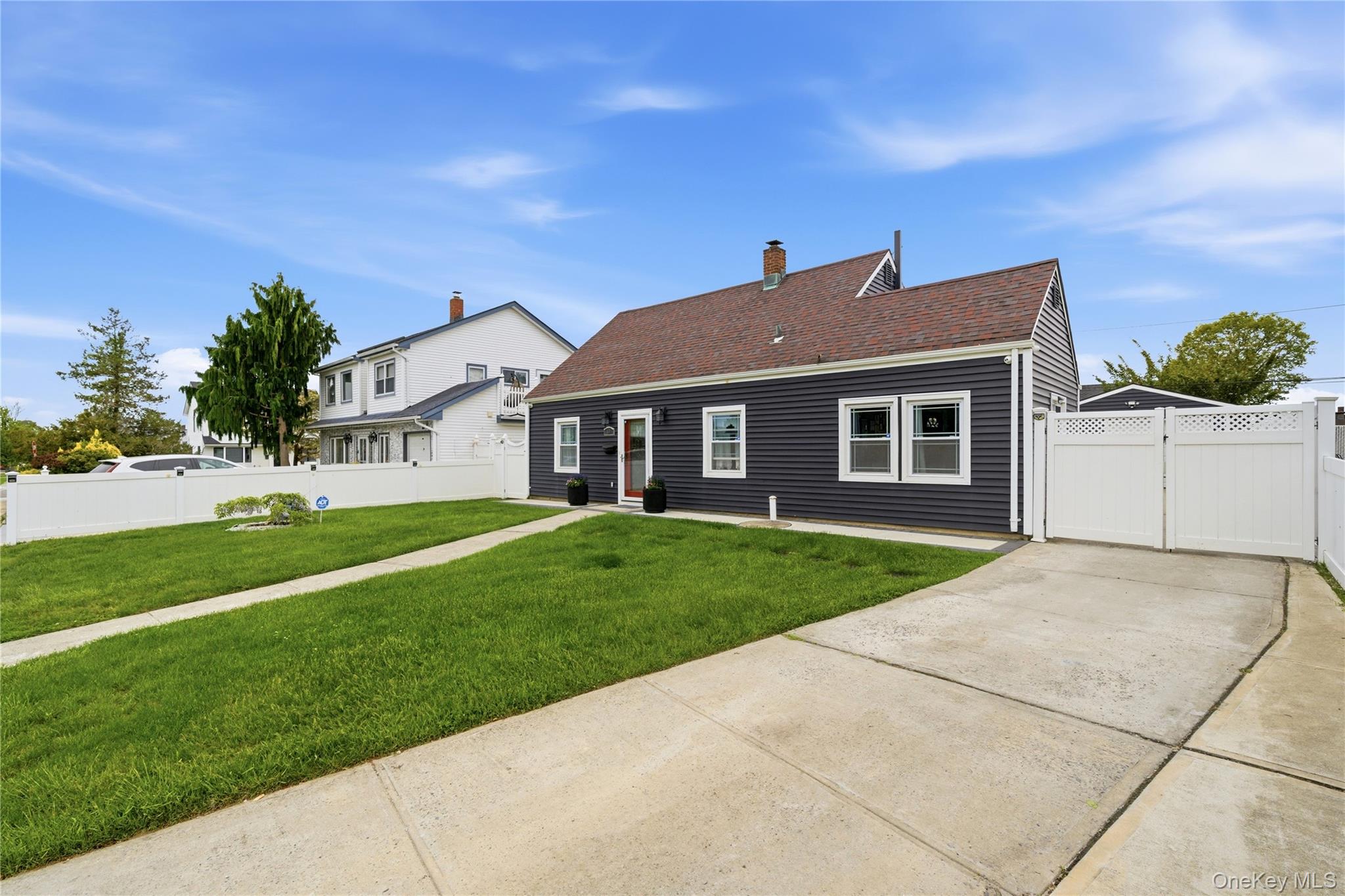 50 Ridge Lane Levittown, NY 11756 - Photo 3 of 27 a front view of a house with a yard
