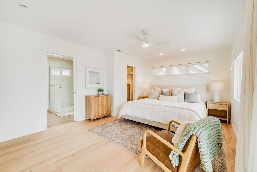 231 5th Street Encinitas, CA 92024 - Photo 22 of 57 a spacious bedroom with a bed and dresser