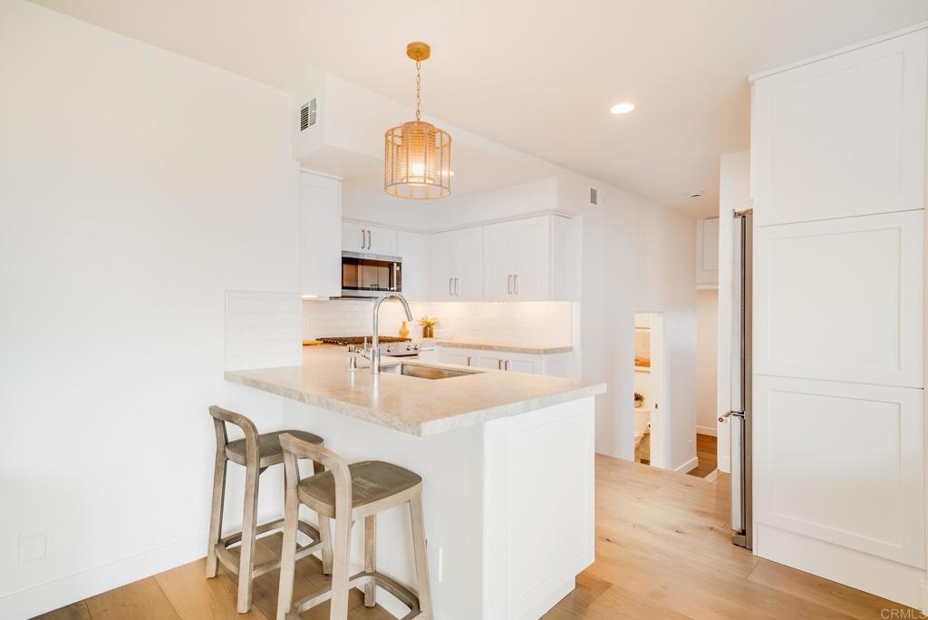 231 5th Street Encinitas, CA 92024 - Photo 34 of 57 a kitchen with a sink and a refrigerator