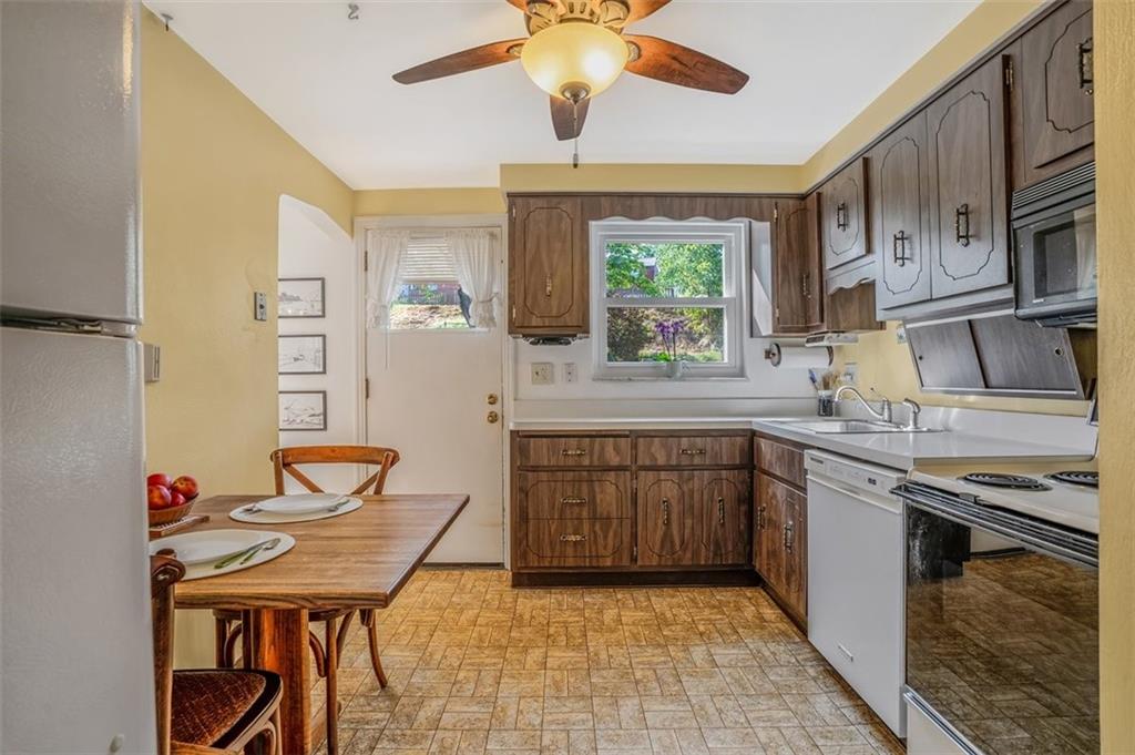263 Mohawk Drive McKeesport, PA 15135 - Photo 7 of 45 a kitchen with stainless steel appliances granite countertop a sink dishwasher stove and refrigerator with wooden floor