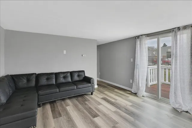 a bedroom with a bed and a dresser next to a window