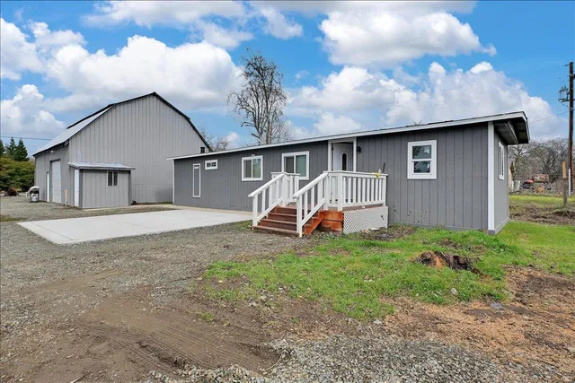 a view of a house with a yard and garage