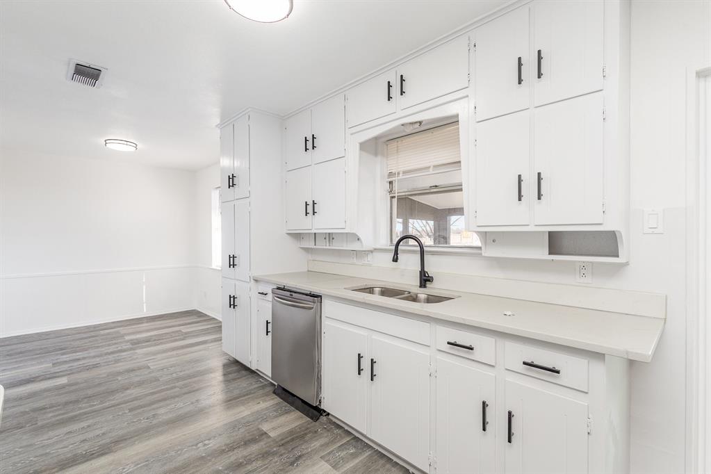 800 Overhill Court Hurst, TX 76053 - Photo 11 of 26 a kitchen with a sink cabinets and wooden floor