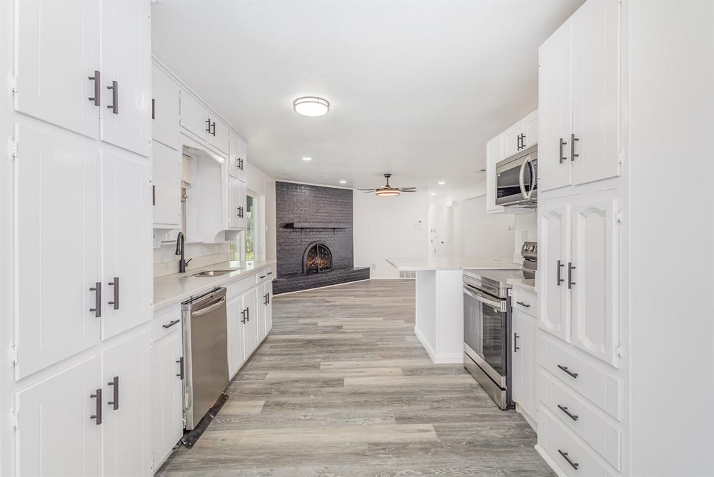 800 Overhill Court Hurst, TX 76053 - Photo 26 of 26 a large white kitchen with granite countertop a large counter top stainless steel appliances and cabinets
