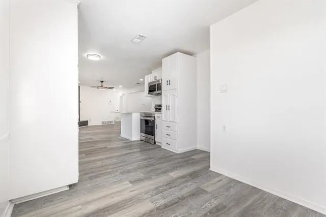 a view of a kitchen with wooden floor
