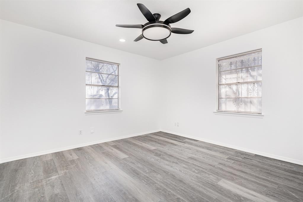800 Overhill Court Hurst, TX 76053 - Photo 13 of 26 wooden floor in an empty room with a window