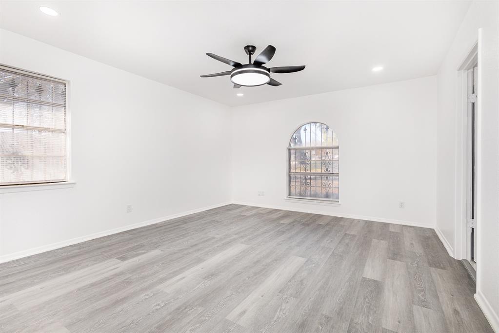 800 Overhill Court Hurst, TX 76053 - Photo 16 of 26 a view of an empty room with wooden floor and a window