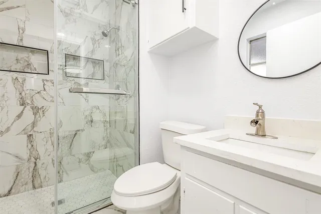 a bathroom with a sink toilet and shower