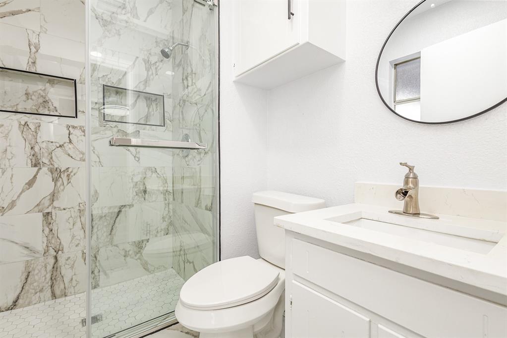 800 Overhill Court Hurst, TX 76053 - Photo 22 of 26 a bathroom with a sink toilet and shower