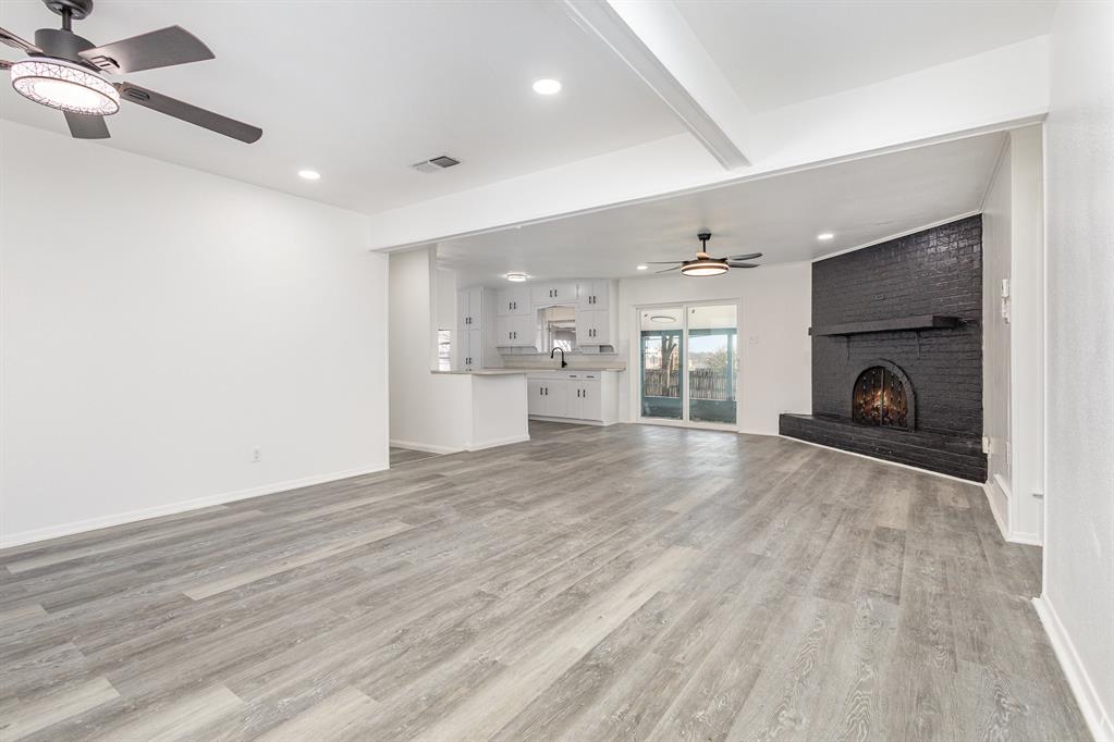 800 Overhill Court Hurst, TX 76053 - Photo 5 of 26 a view of empty room with a fireplace and wooden floor