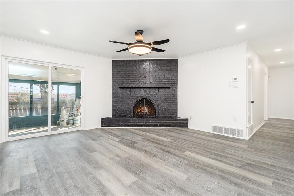 800 Overhill Court Hurst, TX 76053 - Photo 6 of 26 wooden floor fireplace and natural light in room