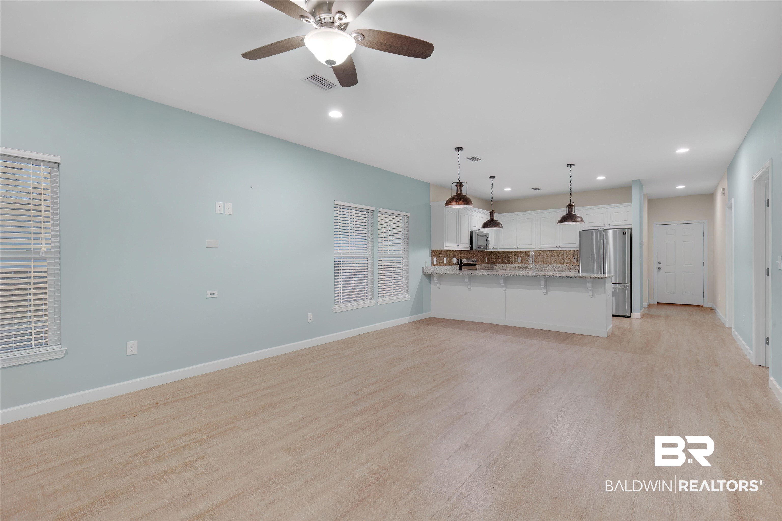 5625 Georgia Street Orange Beach, AL 36561 - Photo 6 of 30 Unfurnished living room featuring light wood-type flooring and ceiling fan