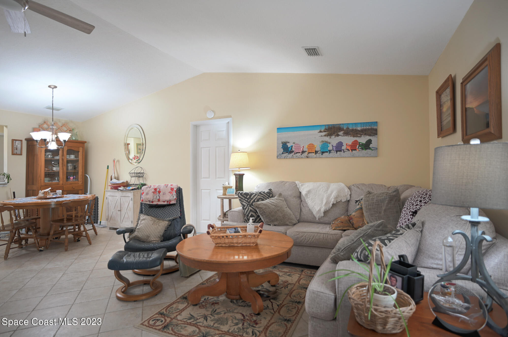 116 Normandy Place Melbourne Beach, FL 32951 - Photo 12 of 24 a living room with furniture and a chandelier