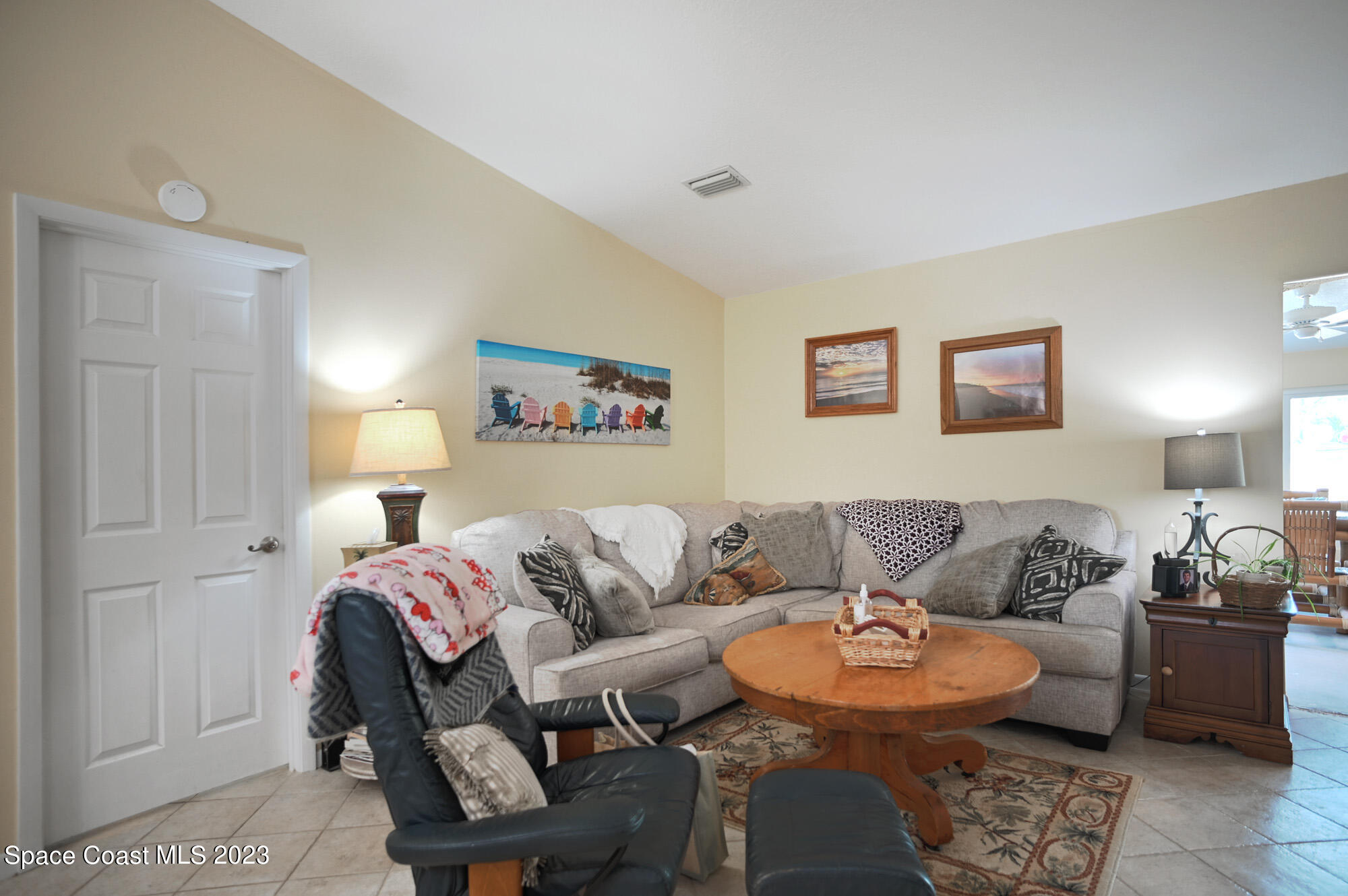 116 Normandy Place Melbourne Beach, FL 32951 - Photo 13 of 24 a living room with furniture and a lamp
