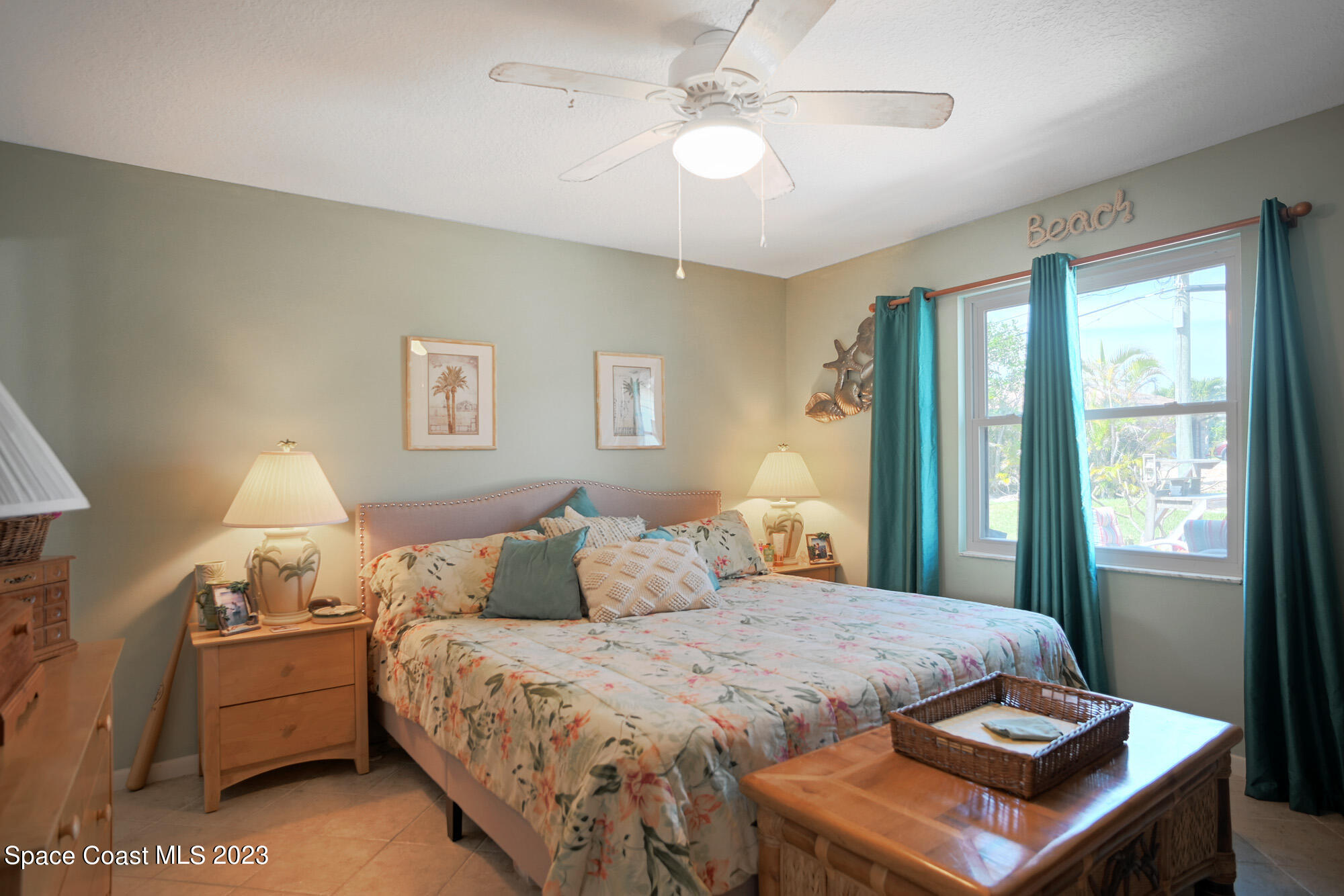 116 Normandy Place Melbourne Beach, FL 32951 - Photo 14 of 24 a bedroom with a bed and a chandelier