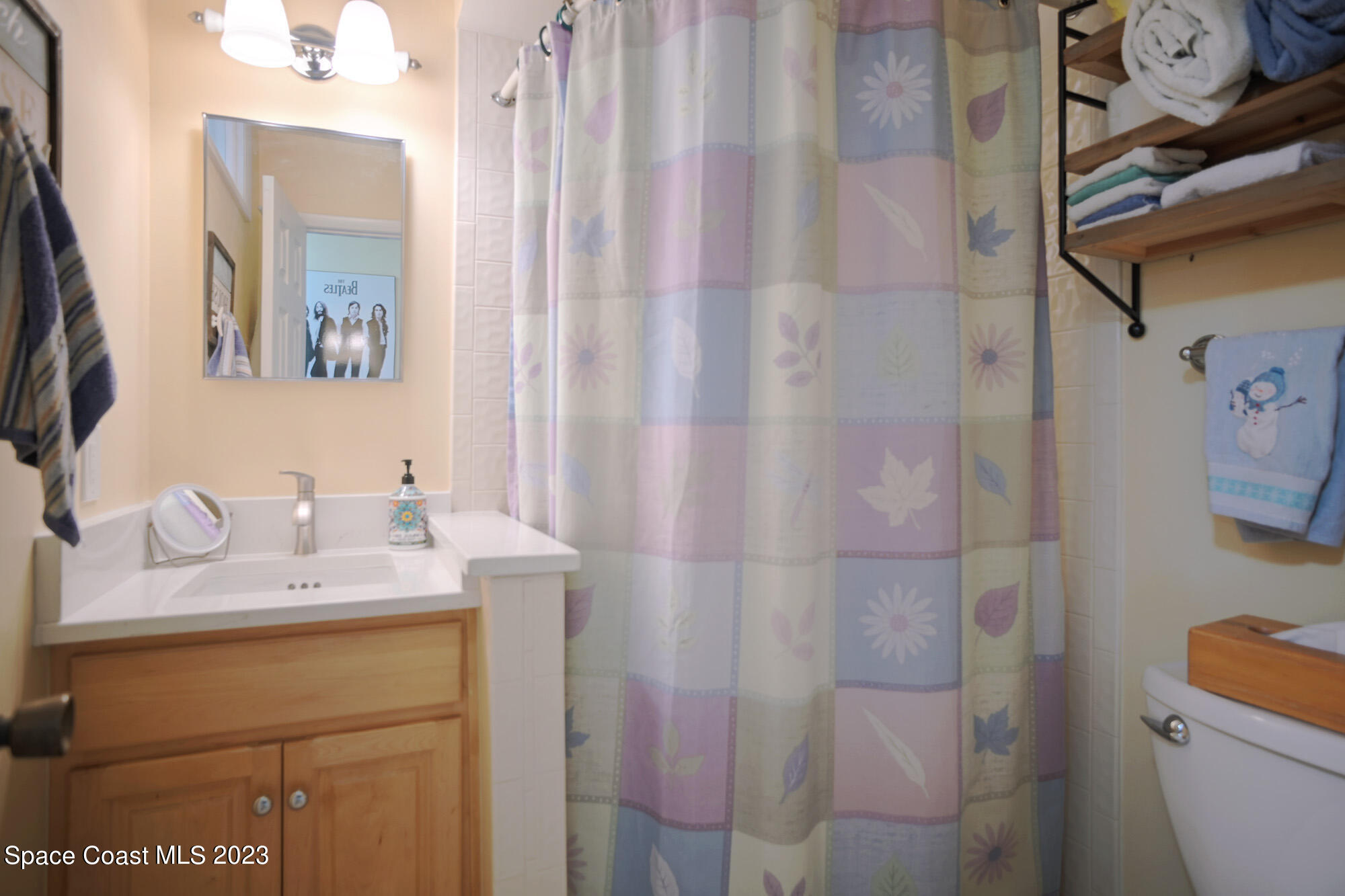 116 Normandy Place Melbourne Beach, FL 32951 - Photo 17 of 24 a bathroom with a granite countertop sink and a mirror