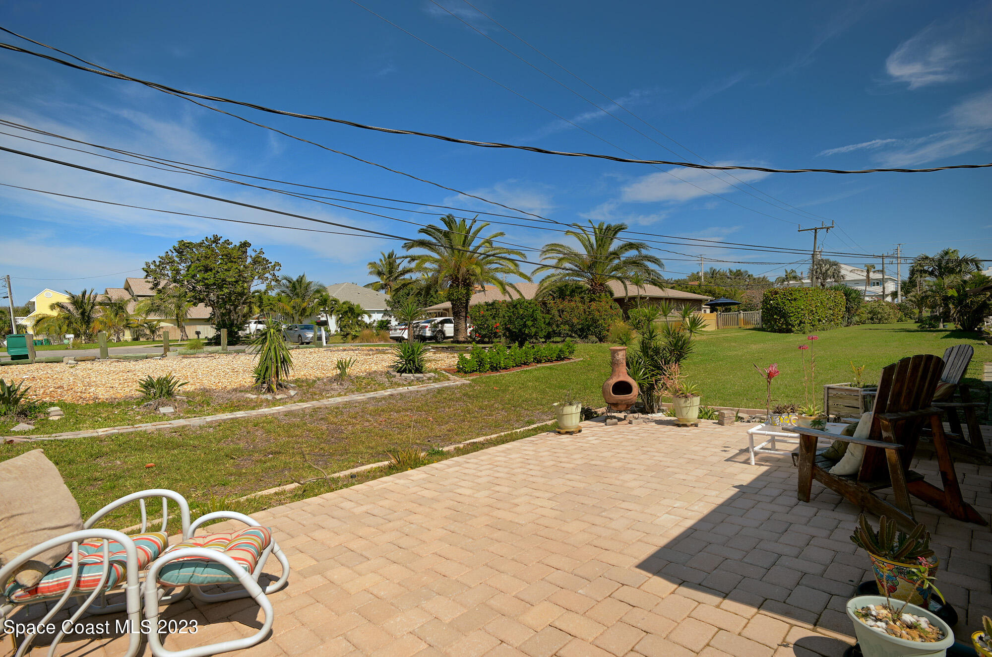 116 Normandy Place Melbourne Beach, FL 32951 - Photo 19 of 24 a view of a swimming pool with a table and chairs in patio